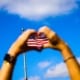 Hands making a heart over the US flag