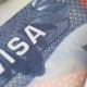 A close up of the word visa on top of a passport.